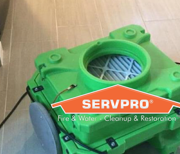 Picture of a green air scrubber with the SERVPRO house logo