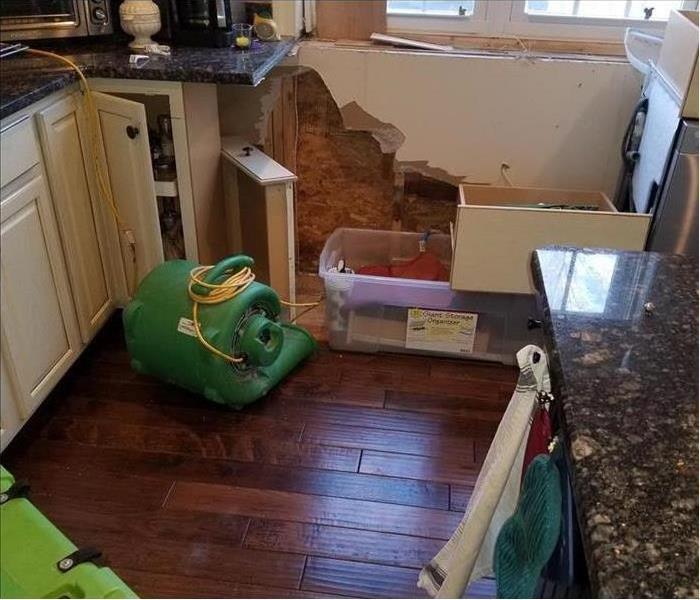 Water damage in a kitchen with drying equipment set up